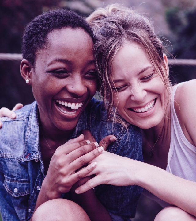 Happy friends holding each other